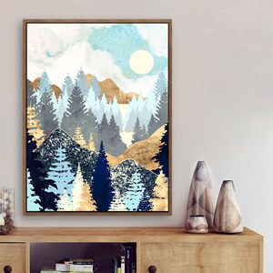 May include: Abstract painting of a forest scene with blue, gold, and white colors. The painting depicts a mountain range with trees and a sun in the sky.