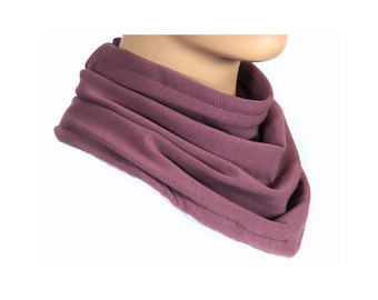 May include: A mauve-colored, soft, knitted neck warmer or scarf. The neck warmer is folded and worn around the neck.