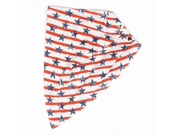 May include: White bandana with a patriotic design featuring red stripes and blue stars. The bandana has a triangular shape and is secured with three metal snaps. The fabric has a slightly distressed look.