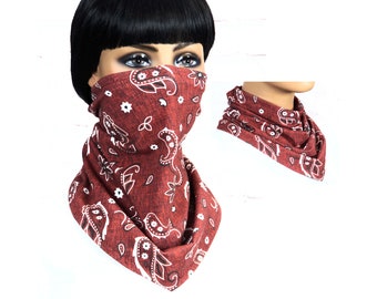 May include: A red bandana with a white paisley pattern. The bandana is worn as a face mask and neck gaiter.
