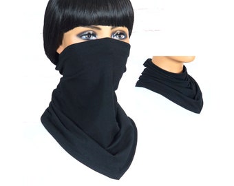 May include: Black neck gaiter made of soft fabric. The gaiter is shown being worn by a person and laid flat.