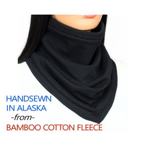 May include: Black hand-sewn neck warmer made from bamboo cotton fleece. The text "HANDSEWN IN ALASKA -from- BAMBOO COTTON FLEECE" is printed below the neck warmer.