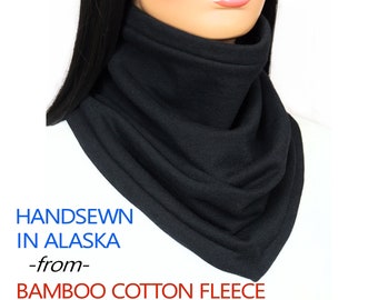 May include: Black hand-sewn neck warmer made from bamboo cotton fleece. The text "HANDSEWN IN ALASKA -from- BAMBOO COTTON FLEECE" is printed below the neck warmer.
