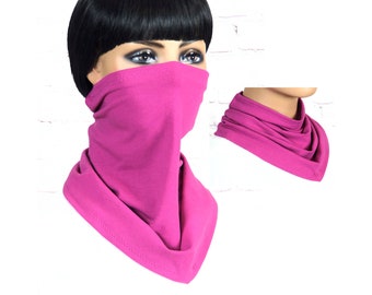 May include: A pink neck gaiter made of soft fabric. The gaiter can be worn as a face mask, neck warmer, or headband.