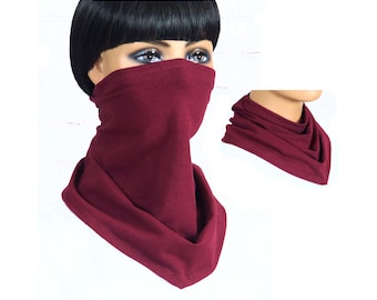 May include: A burgundy neck gaiter made of soft fabric. The gaiter can be worn as a face mask, neck warmer, or headband.