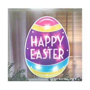 May include: A purple, yellow, pink, and blue Easter egg-shaped sign with the words "Happy Easter" in white letters. The sign has small white lights around the edge.