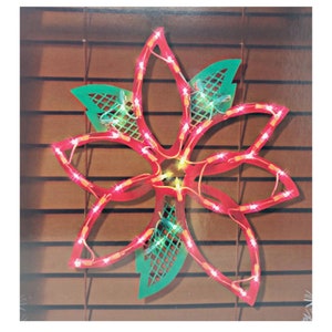 May include: A red and green lighted Christmas poinsettia decoration. The poinsettia is made of wire and has a mesh design. The lights are white and twinkle.