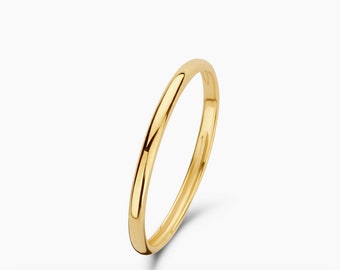 May include: A simple gold band ring. The ring is smooth and polished.
