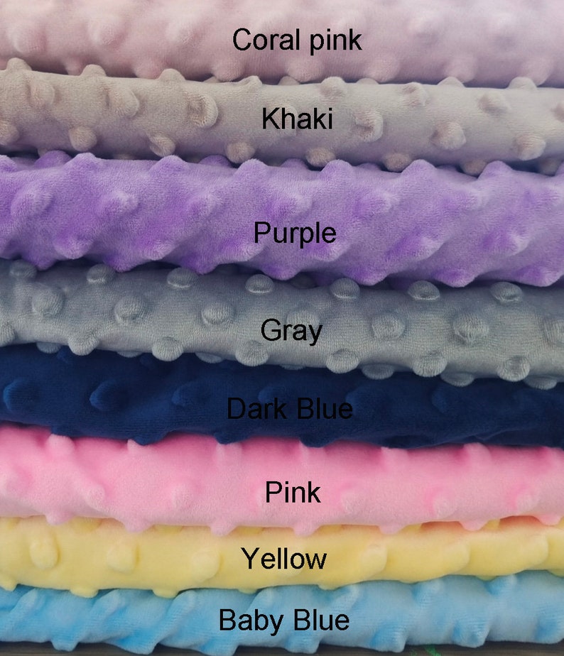 May include: Stack of eight fabric swatches in different colors, including coral pink, khaki, purple, gray, dark blue, pink, yellow, and baby blue. Each swatch has a textured surface with small raised dots.