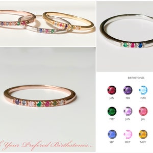 May include: A collection of thin, colorful gemstone rings in rose gold, silver, and gold. Each ring features a row of birthstones. The image includes a chart of birthstones by month and the text "With Your Preferred Birthstones..."