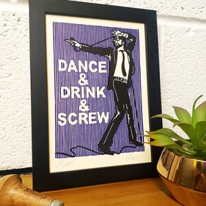 May include: Black framed art print with a man in a suit and the words "DANCE & DRINK & SCREW" in white text on a blue striped background. The artwork is signed by the artist.