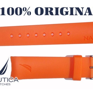 May include: Orange silicone watch band with silver buckle and Nautica logo. The band has multiple holes for adjusting the size.