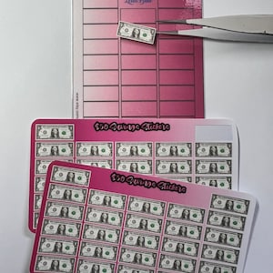 May include: Two sheets of pink and white gradient stickers with images of $50 bills. The top sheet has a single sticker and the text "$50 Savings Challenge" and "Plan with Leila Blue". The bottom sheet has 36 stickers and the text "$50 Savings Stickers".