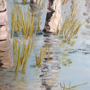 May include: A close-up of a painting depicting a birch forest with white bark and green foliage. The trees are reflected in the water, which is painted in shades of blue and gray. The painting is done in a realistic style with visible brushstrokes.