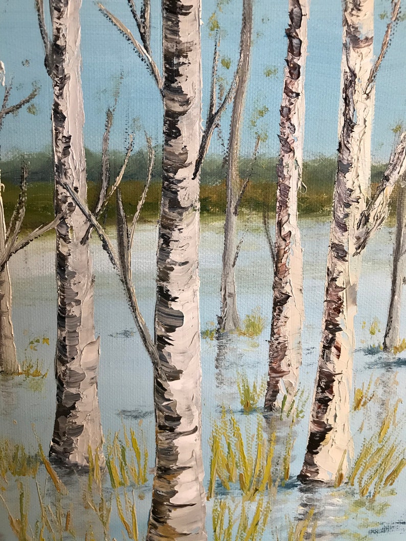 May include: A painting of a birch tree forest with white bark and black markings. The trees are standing in a body of water, with the water level reaching up to the base of the trees. The water is a light blue color, and the sky is a light blue color. The trees are in the foreground of the painting, and the background is a blurry green.