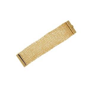May include: A gold mesh bracelet with a clasp that reads "Lavin".
