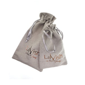 May include: Two gray velvet drawstring pouches with the text "Lavish by Innova Milano" printed in gold on the front.