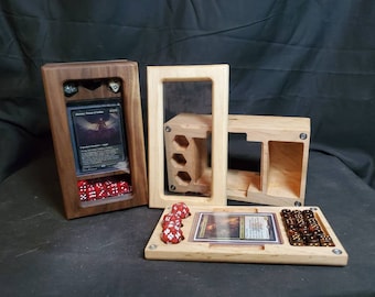 May include: Three wooden boxes for holding dice and trading cards. The boxes are made of walnut and maple wood. The boxes have clear acrylic windows to display the contents. The boxes are designed for tabletop gaming.