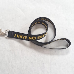 May include: Black lanyard with a silver clip and the text "I have no idea what I'm doing" in yellow.