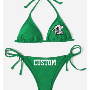 May include: Green bikini top and bottom with white text that says "CUSTOM" on the bottom and a white graphic of a knight on the top that says "Knight's".