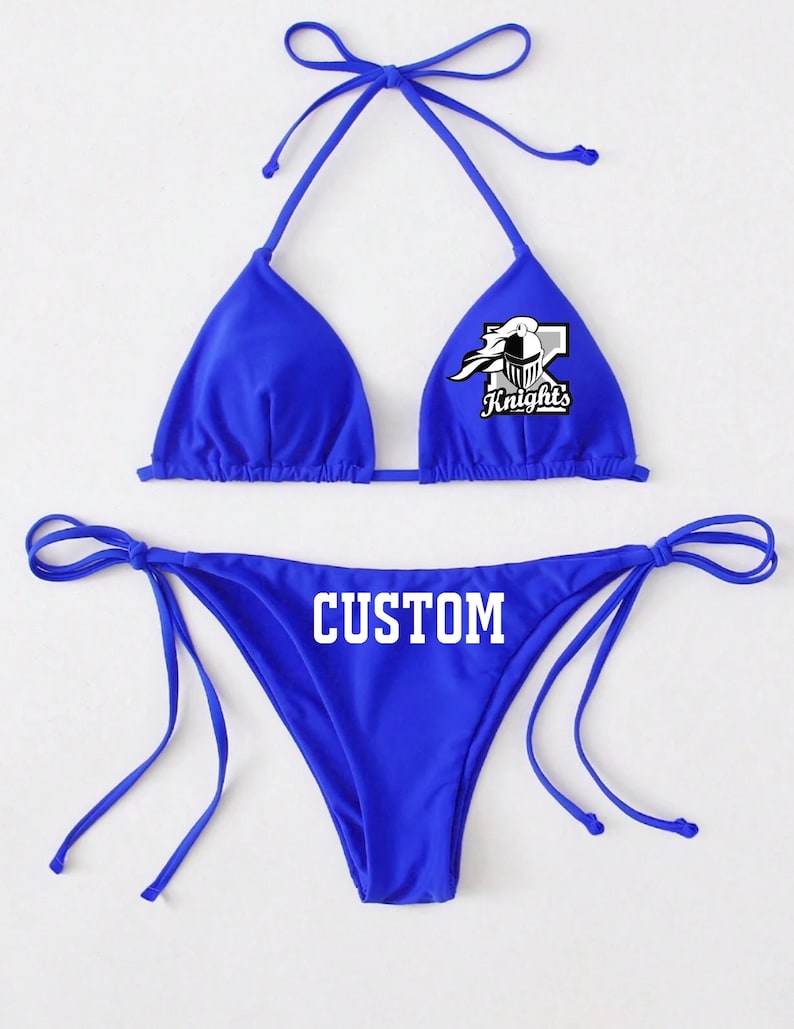 May include: A royal blue bikini with a white graphic of a knight's helmet and the word "Knights" on the top and the word "CUSTOM" on the bottom.