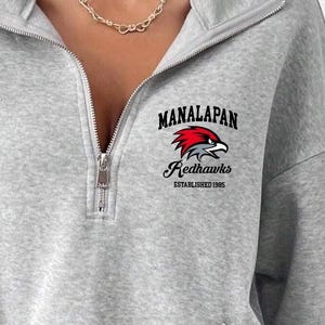 May include: Gray sweatshirt with a zipper and a black and red logo that says "Manalapan Redhawks Established 1985"