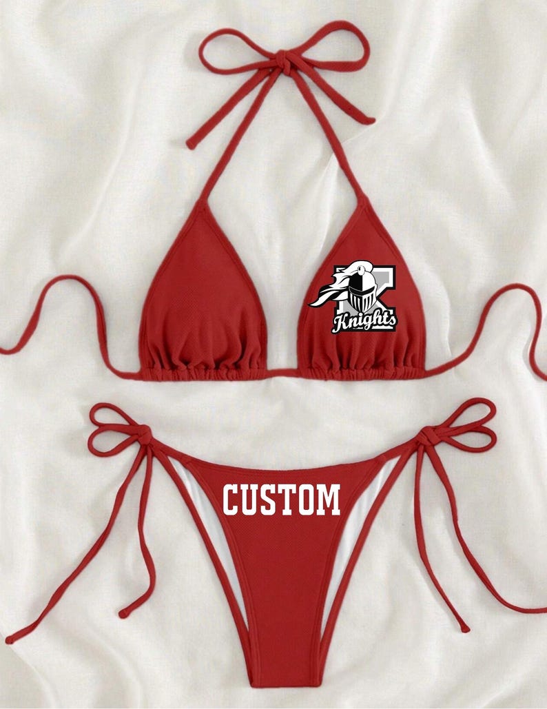 May include: Red bikini with a white logo that says "Knights" on the top and "CUSTOM" on the bottom.