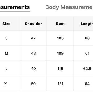 May include: A product measurement chart with body measurements in a table format. The chart includes US sizes, sizes (S, M, L, XL), shoulder measurements (47-50), bust measurements (105-121), length measurements (60-64), and sleeve length measurements (57-60).