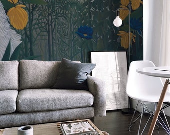 May include: A living room interior featuring a grey sofa, a wooden coffee table, a white chair, and a large wall mural depicting a jungle scene with yellow flowers and a blue flower.