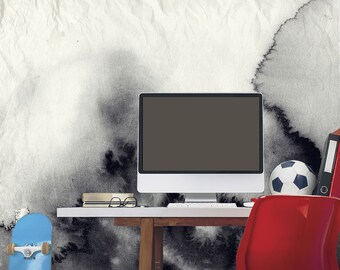 May include: A white desk with a computer, a blue skateboard, a red chair, a soccer ball, and a stack of books. The wall behind the desk has a black and white watercolor design.