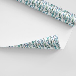 May include: White wrapping paper with a repeating pattern of blue and green watercolor cactus illustrations.