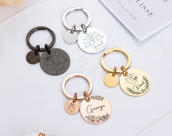 May include: Four personalized keychains with different designs. Each keychain features a round metal tag with a name and a small charm. The keychains are in black, silver, gold, and rose gold.