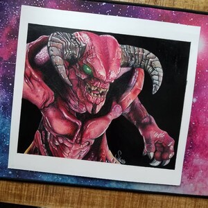 May include: A detailed pencil drawing of a red demon with large horns and sharp teeth. The demon is depicted in a menacing pose with its claws extended.