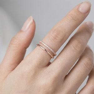 May include: A white ceramic mug with a black handle and the text "But First, Coffee" in a bold, black font. The mug is set against a neutral background, highlighting its simple design.