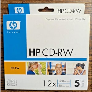 May include: A package of HP CD-RW discs. The packaging is white and blue, with the HP logo and the text "HP CD-RW." It includes 12 discs, with 700 MB data capacity and 80 min music capacity. The package also says "Superior Performance and HP Quality."