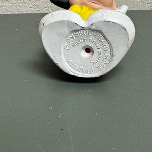 May include: A vintage Playskool Baby Mickey Mouse figurine. The bottom of the white figurine has the text "Playskool Baby Made in China Walt Disney Company". The figure has a yellow shirt and black ears.