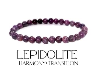 May include: A purple lepidolite beaded bracelet. The bracelet is made of small, round, polished beads in shades of deep purple. The text "LEPIDOLITE HARMONY • TRANSITION" is below the bracelet.