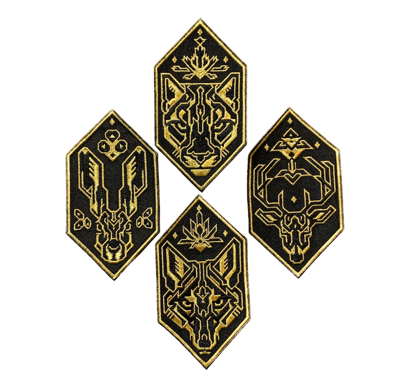 May include: Four black and gold embroidered patches featuring geometric animal designs. The patches are shaped like hexagons and feature a wolf, a deer, a cougar, and a rabbit.