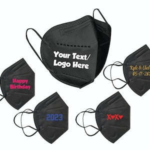 May include: Black face masks with various text and designs. One mask has "Your Text/Logo Here" in white. Others say "Happy Birthday," "Kyle & Chelsea 05-17-2023," "2023," and "XOXO" in different colors.