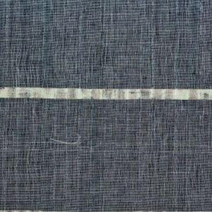 May include: Close-up of a textured fabric with a dark blue woven background. Two horizontal bands of off-white and light gray run across the fabric. The fabric has a slightly irregular weave, creating a subtle pattern.
