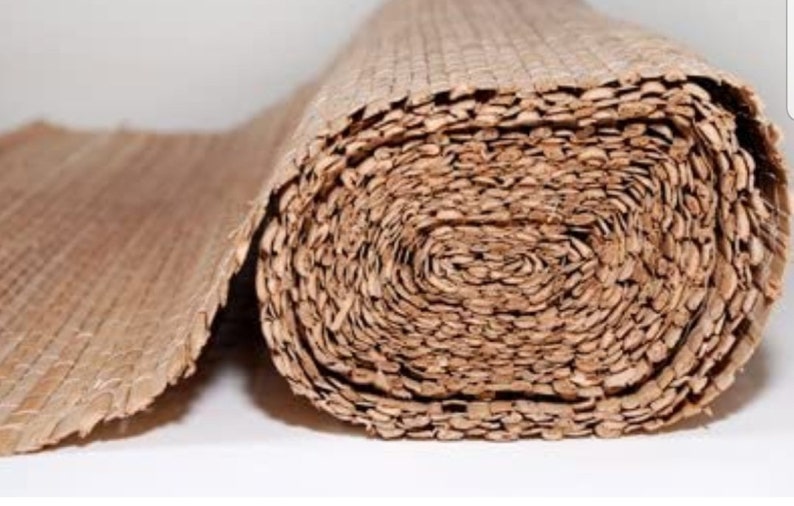 May include: A roll of natural brown woven material, possibly for crafting or home decor. The material is tightly woven and has a natural, rustic look.