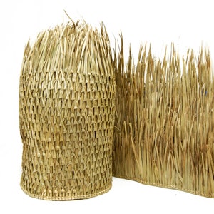 May include: A woven straw mat with a textured, woven pattern. The mat is made of natural, light brown straw and is ideal for adding a rustic touch to any space.