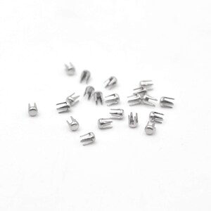 May include: A scattering of silver-toned metal rivets with a star-shaped base and a domed top.