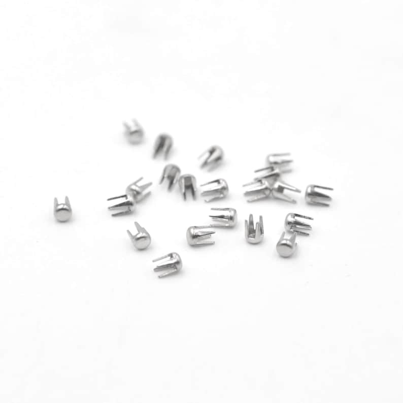 May include: A scattering of silver-toned metal rivets with a star-shaped base and a domed top.