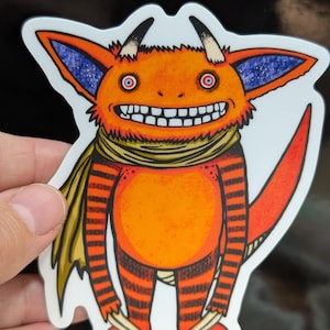 May include: A sticker featuring a cartoon monster with orange skin, red stripes, and a yellow scarf. The monster has large teeth, horns, and a long tail. The sticker has the text "@BoeGeOB" at the bottom.