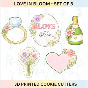 May include: Set of five 3D printed cookie cutters with a floral and love theme. Designs include a diamond ring, an oval with the text "LOVE in bloom", a champagne bottle, a bouquet of flowers, and a heart.