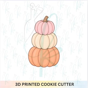 May include: A 3D printed cookie cutter shaped like a stack of three pumpkins. The top pumpkin is light pink, the middle is cream, and the bottom is orange. Each pumpkin has a brown stem. The text 3D PRINTED COOKIE CUTTER is at the bottom.