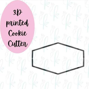 May include: A black hexagonal cookie cutter with a thin frame. To the left, a pink oval contains the black text 3D printed Cookie Cutter. The background features a repeating light blue pattern of the letter k in a cursive script font.