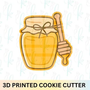 May include: A 3D printed cookie cutter in the shape of a honey jar with a honey dipper. The jar is yellow with a plaid pattern and a brown lid tied with a bow. The honey dipper is light brown. The text "3D PRINTED COOKIE CUTTER" is at the bottom.