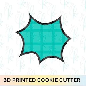May include: A teal-colored, starburst-shaped cookie cutter with a black outline and a plaid pattern inside. The text "3D PRINTED COOKIE CUTTER" is at the bottom of the image.